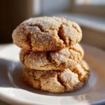 A stack of three chewy brown butter sugar cookies generously coated in sparkling granulated sugar.