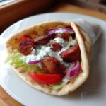 A delicious smoked andouille sausage gyros served in a warm pita with lettuce, tomato, red onion, and tzatziki sauce.