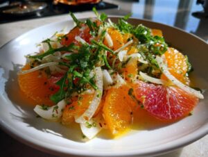 A bright, refreshing citrus salad featuring orange and grapefruit segments, shaved fennel, and arugula tossed in a light dressing.