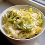 Close-up of tender cabbage coated in a creamy sauce, representing the Cabbage Alfredo dish.